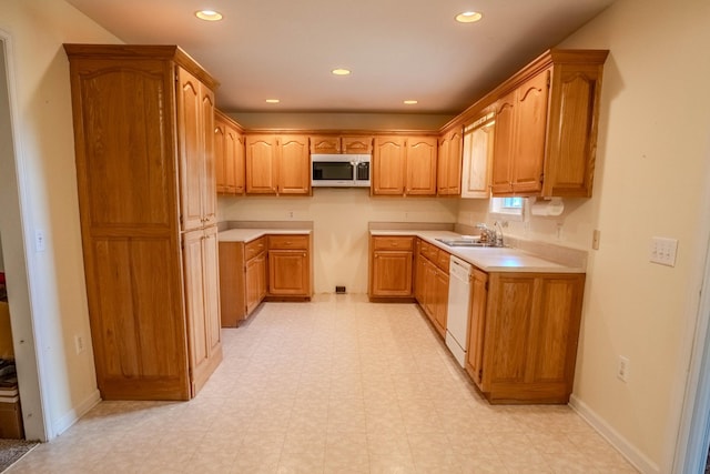 1876 Fall River Rd, Lawrenceburg, TN 38464 - kitchen featuring stainless steel microwave, a sink, white dishwasher, recessed lighting, and brown cabinetry
