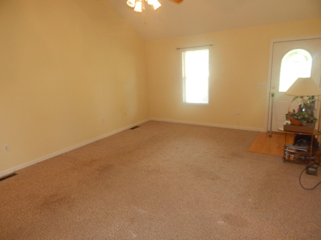 1876 Fall River Rd, Lawrenceburg, TN 38464 - unfurnished living room featuring a ceiling fan, carpet, lofted ceiling, and baseboards
