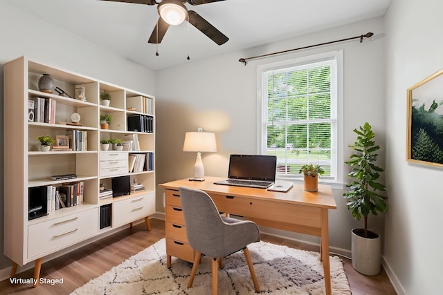 office with light wood-style floors, baseboards, and a ceiling fan