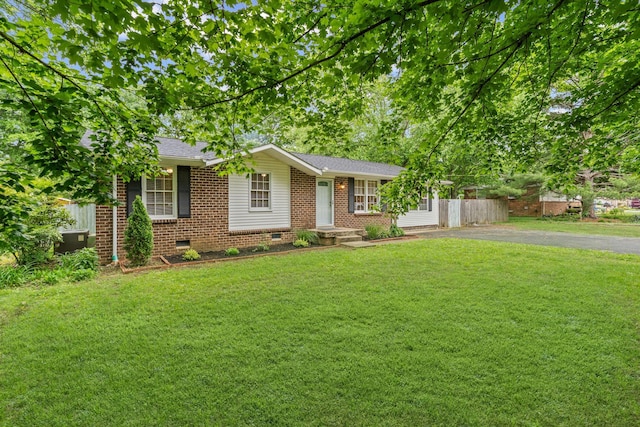 ranch-style house with a front yard, aphalt driveway, brick siding, and crawl space