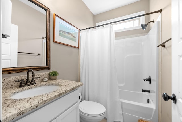 bathroom with toilet, vanity, and shower / bath combo with shower curtain