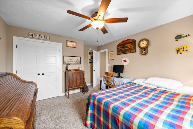 carpeted bedroom with ceiling fan, a closet, and baseboards