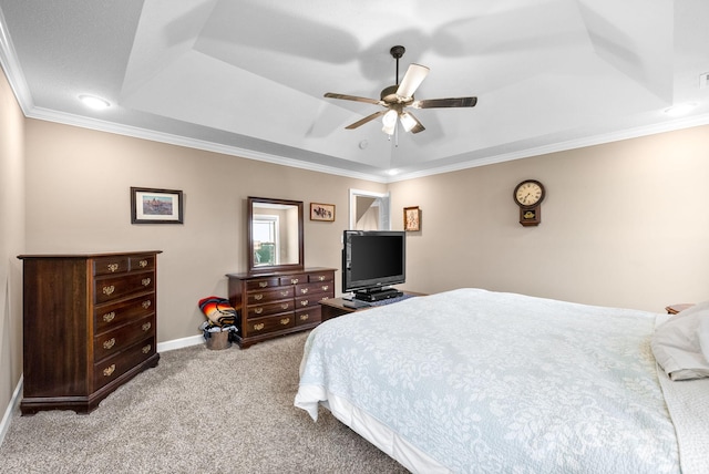 bedroom featuring carpet, baseboards, ornamental molding, ceiling fan, and a raised ceiling