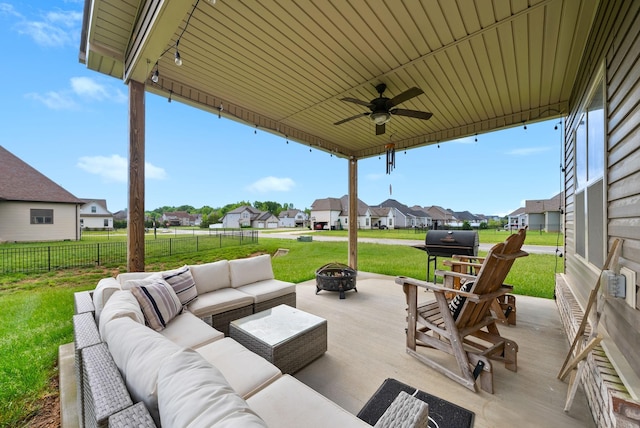 view of patio with fence, a residential view, grilling area, a ceiling fan, and an outdoor living space with a fire pit