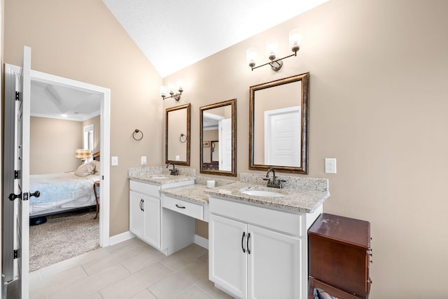 full bath featuring ensuite bathroom, double vanity, a sink, and vaulted ceiling