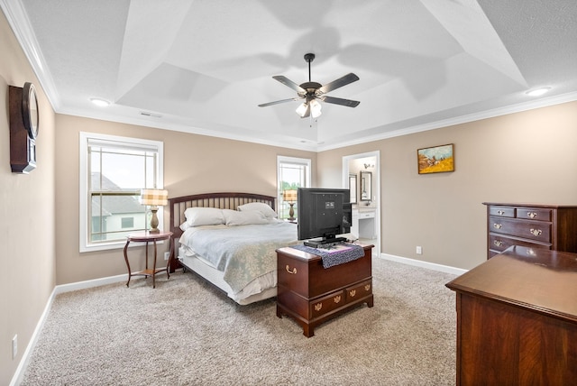 bedroom featuring ornamental molding, a tray ceiling, and light colored carpet