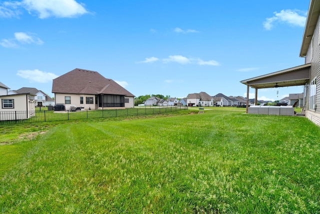 view of yard featuring fence and a residential view
