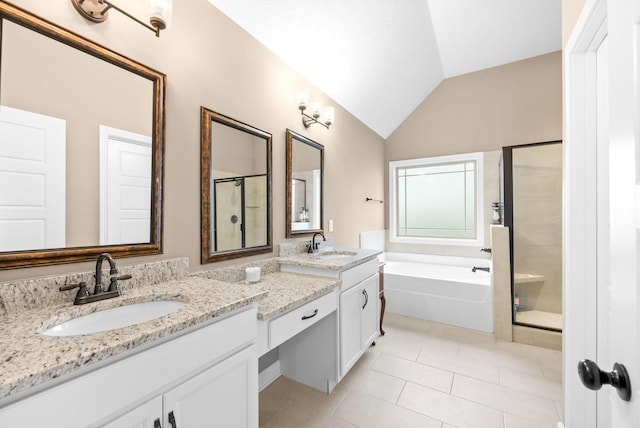bathroom with tile patterned floors, a stall shower, a garden tub, and a sink