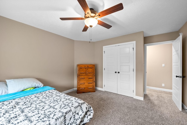 bedroom with a closet, baseboards, a ceiling fan, and carpet