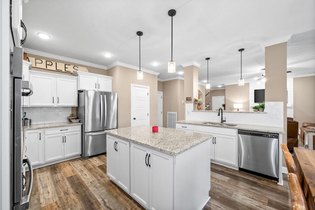 kitchen featuring a sink, ornamental molding, stainless steel appliances, and backsplash