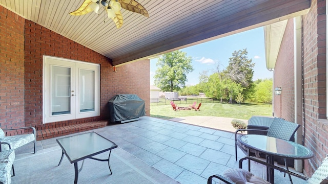 view of patio featuring a grill, french doors, ceiling fan, and fence