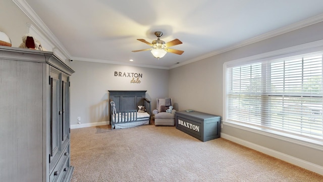 bedroom featuring baseboards, a ceiling fan, crown molding, and light colored carpet