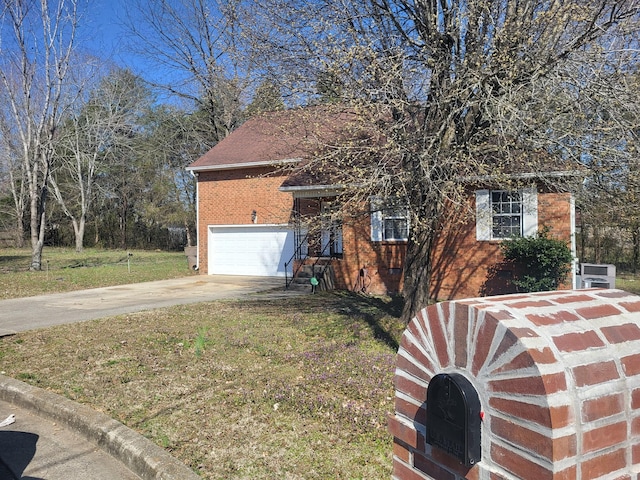 view of front of house with brick siding, driveway, a front lawn, and a garage