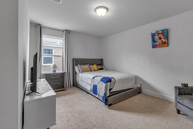 bedroom with light carpet and baseboards