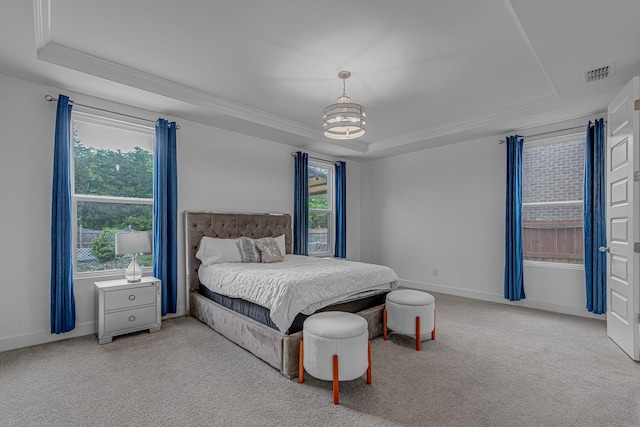 bedroom featuring a raised ceiling, ornamental molding, carpet, a chandelier, and baseboards