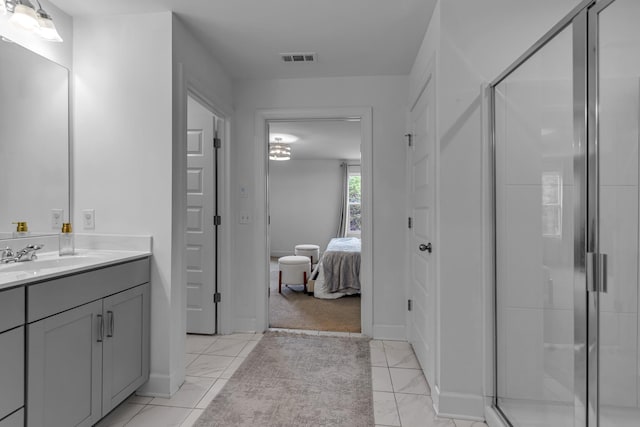 full bath featuring a shower stall, vanity, marble finish flooring, and ensuite bath