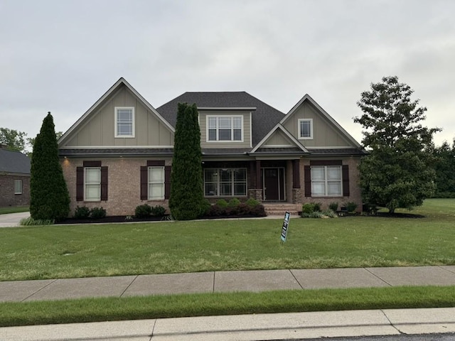 craftsman inspired home with board and batten siding, a front yard, brick siding, and a porch