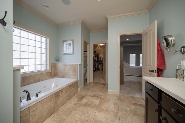 bathroom with crown molding, a whirlpool tub, a spacious closet, vanity, and baseboards