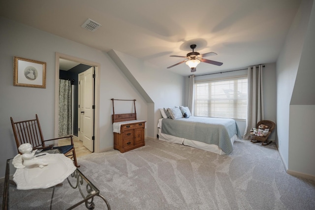 bedroom with light carpet, ceiling fan, and baseboards