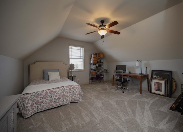carpeted bedroom with lofted ceiling, a desk, ceiling fan, and baseboards