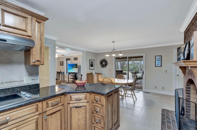 121 Grassland Dr, Gallatin, TN 37066 - kitchen with a brick fireplace, tasteful backsplash, under cabinet range hood, light tile patterned flooring, and a peninsula