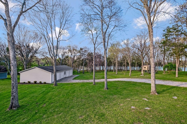 121 Grassland Dr, Gallatin, TN 37066 - view of green lawn featuring curved driveway, a garage, and view of scattered trees