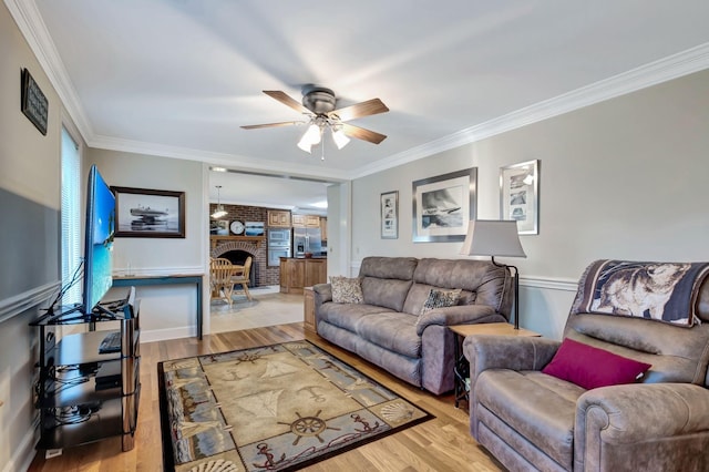 121 Grassland Dr, Gallatin, TN 37066 - living room with ornamental molding, a ceiling fan, wood finished floors, a wainscoted wall, and a brick fireplace