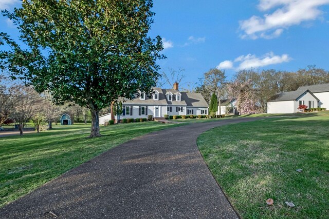 121 Grassland Dr, Gallatin, TN 37066 - view of front of home featuring a front yard, asphalt driveway, and a chimney