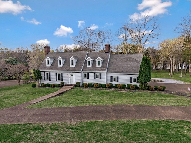 121 Grassland Dr, Gallatin, TN 37066 - new england style home featuring a chimney, a front lawn, and a shingled roof