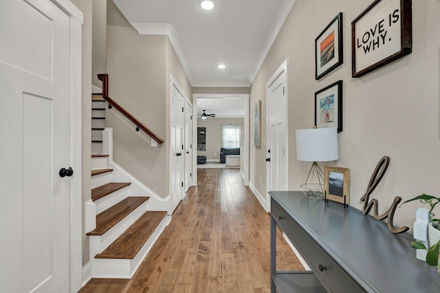 foyer featuring stairs, ornamental molding, wood-type flooring, recessed lighting, and baseboards
