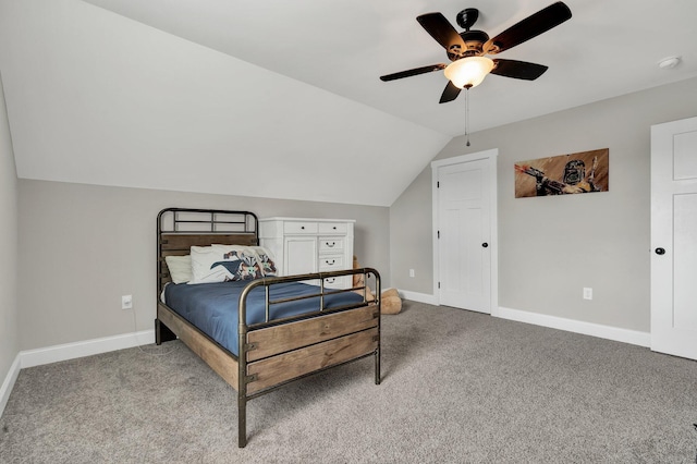 carpeted bedroom with baseboards, vaulted ceiling, and ceiling fan