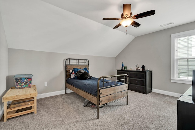 carpeted bedroom featuring vaulted ceiling, baseboards, and ceiling fan