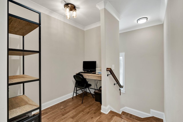 office featuring baseboards, ornamental molding, and wood finished floors