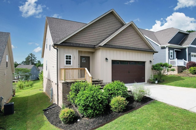 view of front of property featuring a garage, board and batten siding, concrete driveway, and central air condition unit
