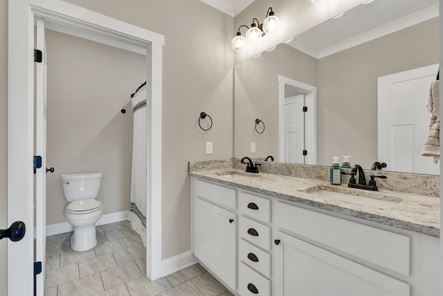 full bathroom featuring toilet, double vanity, baseboards, and ornamental molding