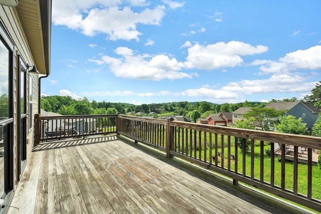wooden deck featuring a lawn