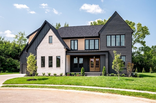 view of front of home featuring board and batten siding, a porch, an attached garage, a front lawn, and driveway