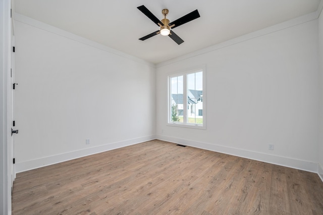 spare room with light wood-style floors, baseboards, and ceiling fan