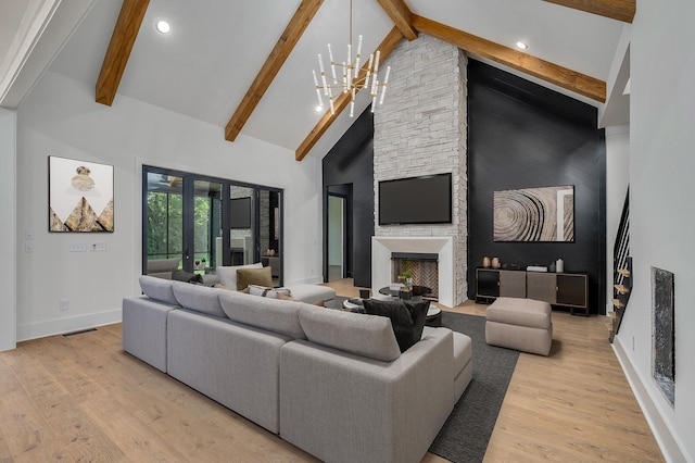 living room with light wood finished floors, baseboards, beamed ceiling, a fireplace, and high vaulted ceiling