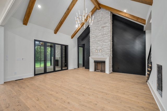 unfurnished living room with wood finished floors, a stone fireplace, high vaulted ceiling, beamed ceiling, and baseboards