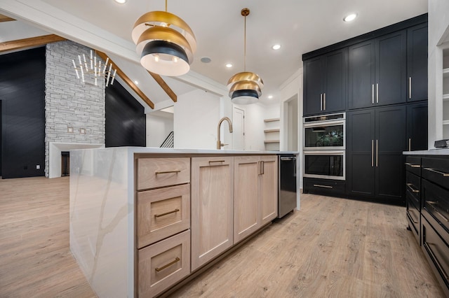 kitchen with double oven, light wood-style flooring, light brown cabinetry, decorative light fixtures, and recessed lighting