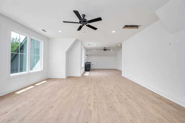 unfurnished living room featuring ceiling fan, baseboards, light wood finished floors, and recessed lighting