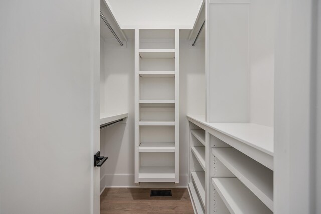 spacious closet featuring dark wood-type flooring