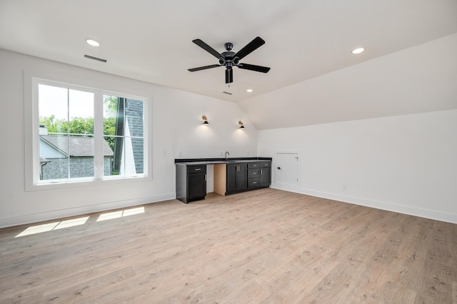 unfurnished living room with light wood-style flooring, vaulted ceiling, baseboards, ceiling fan, and recessed lighting