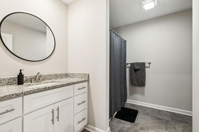 full bath with baseboards and vanity