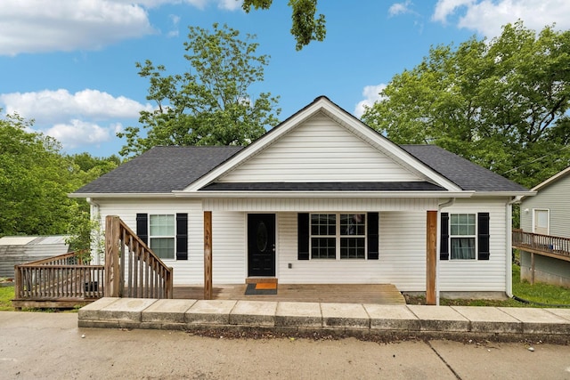 bungalow featuring a shingled roof and a porch