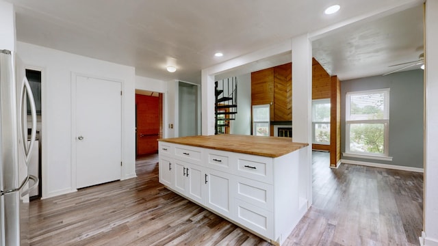 5900 New Hope Ct, Hermitage, TN 37076 - kitchen featuring freestanding refrigerator, butcher block countertops, white cabinetry, light wood-type flooring, and a fireplace