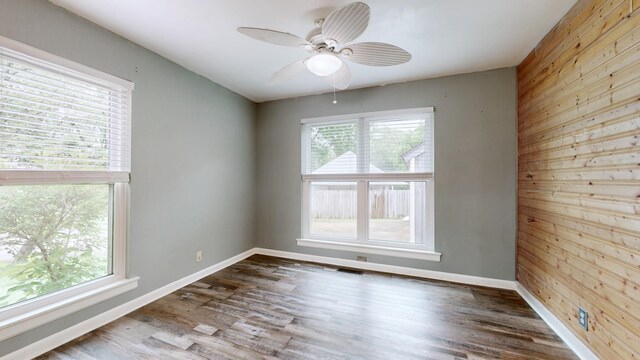 5900 New Hope Ct, Hermitage, TN 37076 - spare room with wooden walls, wood finished floors, ceiling fan, and baseboards