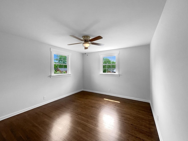 unfurnished room featuring a ceiling fan, baseboards, and wood finished floors
