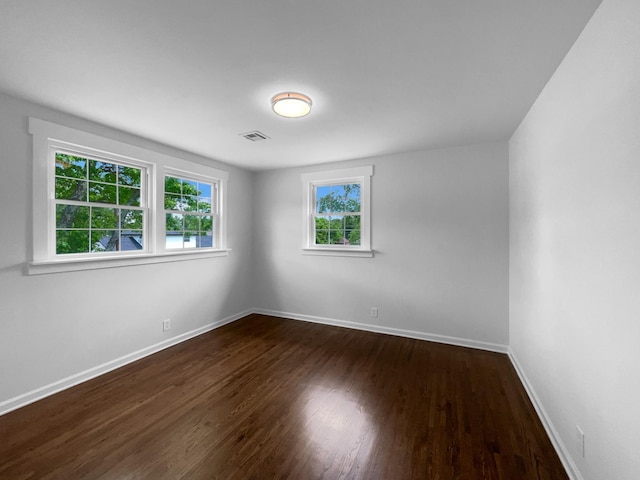 unfurnished room featuring dark wood finished floors and baseboards